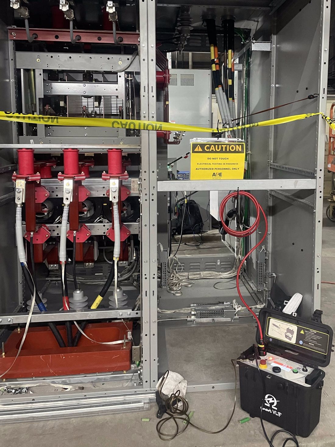 VLF cable testing on medium-voltage switchgear with caution barrier